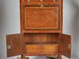 a small wooden cabinet with a drawer on top of it