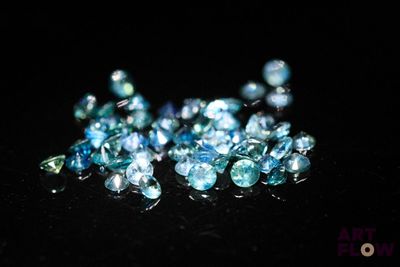 some very pretty blue and green crystals on a black surface
