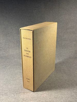 a book with a gold cover sitting on top of a table