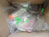 a box full of assorted items sitting on a couch