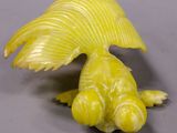 a yellow bird that is sitting on a table