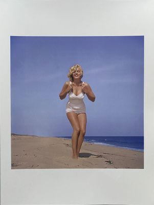photograph of a woman in a white bathing suit on a beach