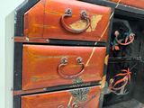 an old chest of drawers with many drawers on it