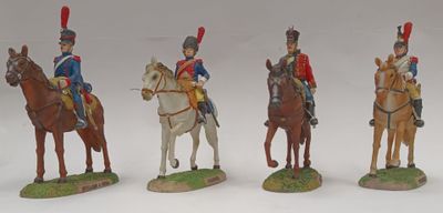 four figurines of soldiers riding horses on a white surface