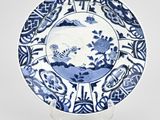 a blue and white plate with a design on it