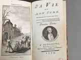 someone is holding an open book with a picture of a man and a horse