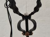 a metal pole with a metal object attached to it