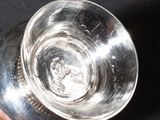a person holding a glass of water in their hand