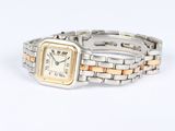 a silver and gold wrist watch on a white surface