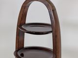 a three tiered wooden table with plates on it