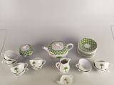 a lot of cups and saucers that are sitting on a table