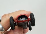 a hand holding a small toy car in it ' s palm