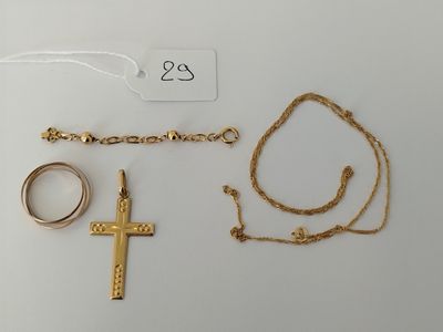 a close up of a cross, a ring, and a chain