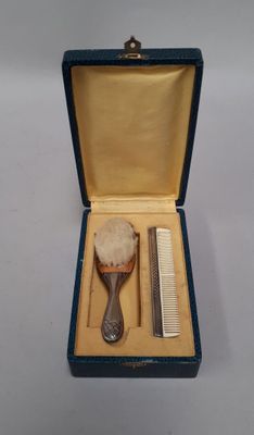a small blue box with a comb, comb, and a comb in it