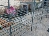 a metal rack that has been placed on the ground in front of a brick wall