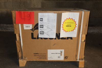 a cardboard box sitting on top of a pallet in a garage