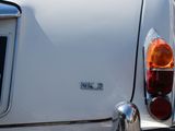 a close up of a white car with a number plate on it