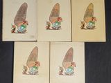 four cards with cartoon characters on them on a black surface