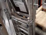 a picture of a stainless steel ladder in a warehouse