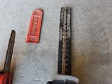 two chainsaws that are laying on the floor