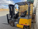 a forklift that is parked in front of a building