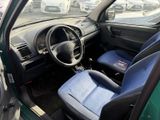 dashboard of a car with blue seats and a steering wheel