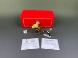 a toy of a man riding a bike next to a red box