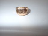 an image of a gold signet ring with a lion on it
