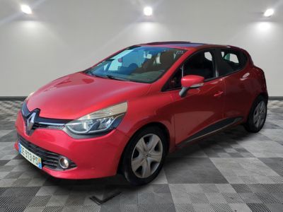 a red car is parked in a room with a checkered floor
