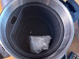 a blender with ice cubes inside of it on a table