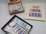 two boxes of stamps are sitting on a table next to a box of stamps