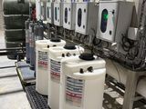 a row of water tanks lined up in a factory