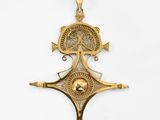 an image of a gold pendant with a tree on it