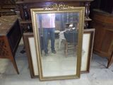 a man standing in front of a mirror in a room