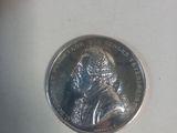 a close up of a coin with a picture of a man on it
