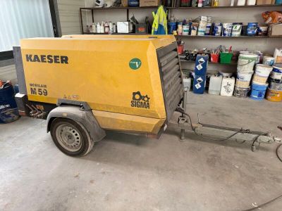 a small yellow machine that is parked in a garage