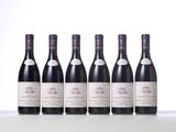 six bottles of wine are lined up on a table
