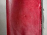 a red cloth with a small hole in the middle of it