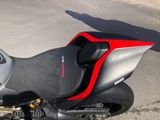 a black and red motorcycle parked on the side of the road