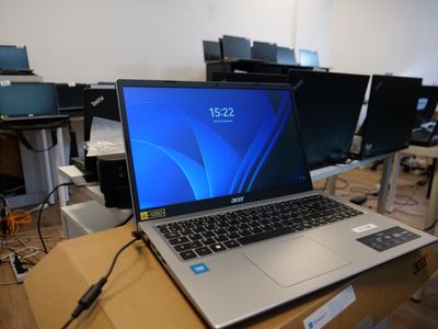 a laptop computer sitting on a table in a room