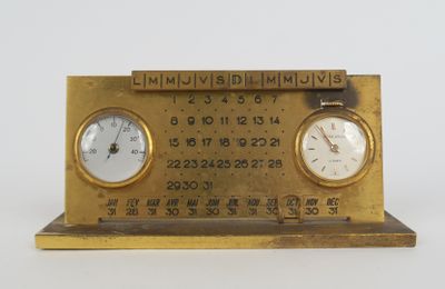 two clocks on a brass clock stand with numbers on it