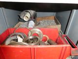 a red container filled with different types of metal parts
