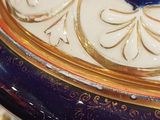 a blue and white vase with a gold lid