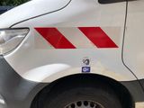 a white van with a red stripe on the side of it