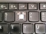 a close up of a black keyboard with a picture of a person on it
