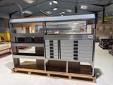 a metal cabinet with drawers and drawers on a pallet in a warehouse