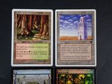 three cards with different designs on them are sitting on a table
