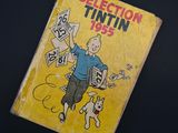 a yellow book with a picture of a man and a dog on it