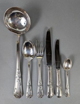 beaucoup d'argenterie sur une table avec une cuillère et un couteau