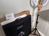 a light that is sitting on a tripod next to a box